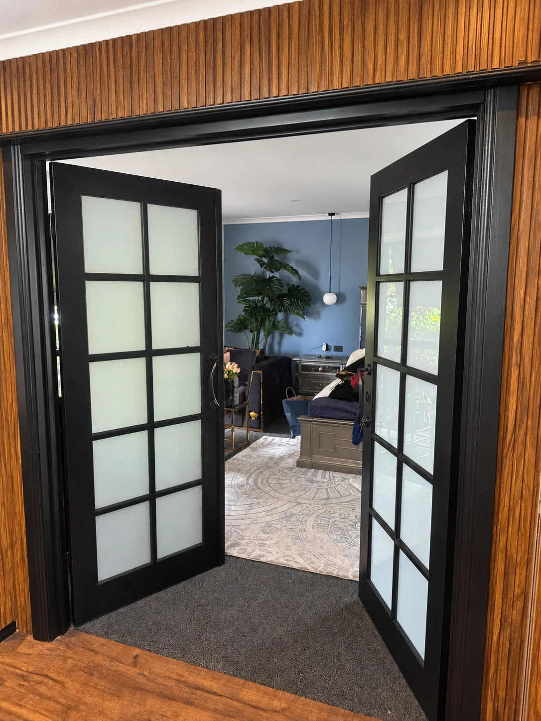 Dark glazed double doors in a timber surround
