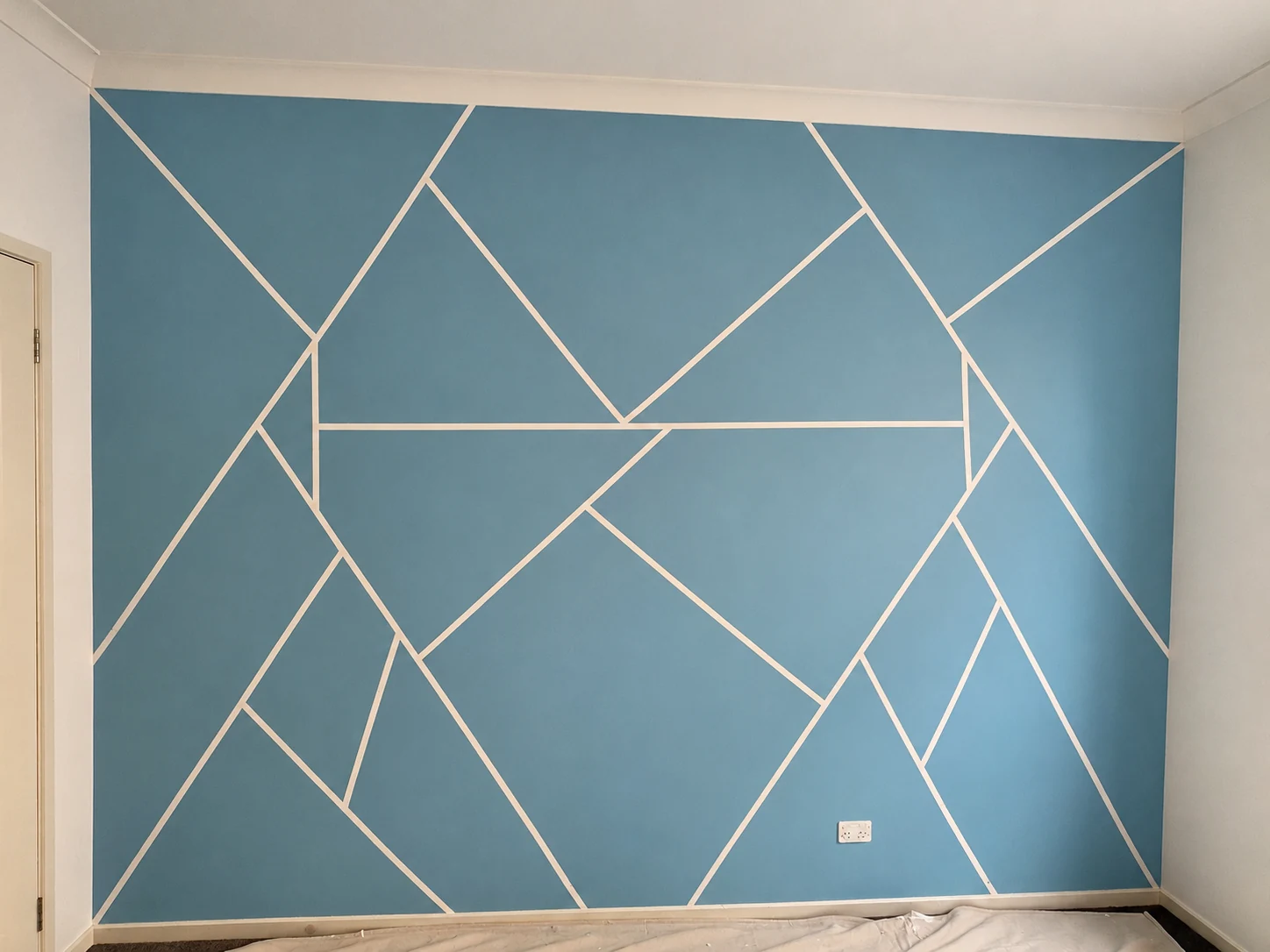 Glorious Painter job photo: blue geometric feature wall with light intersecting lines