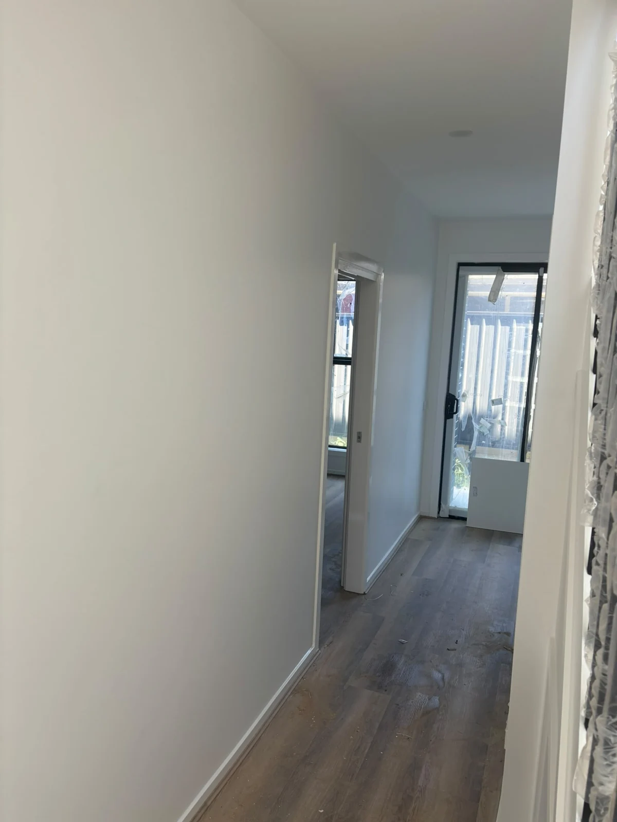 Light painted corridor with timber-look flooring