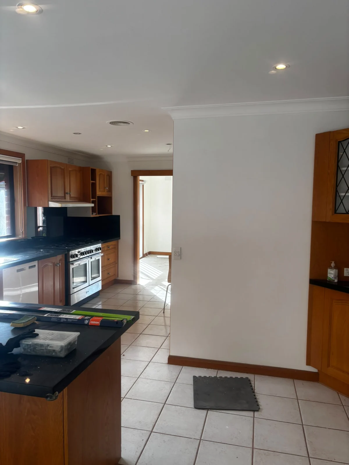 Light living and kitchen interior with timber cabinetry