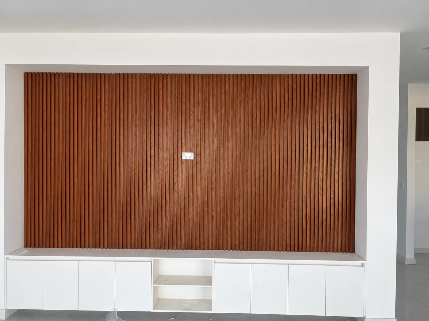 Vertical timber feature wall above white cabinetry
